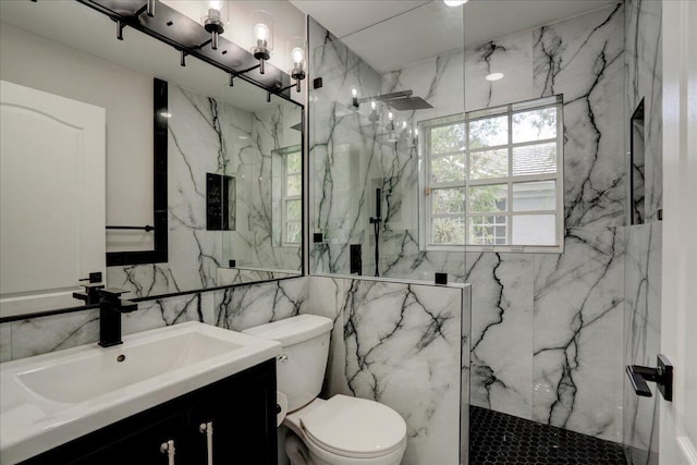 bathroom with vanity, toilet, tile walls, and a tile shower