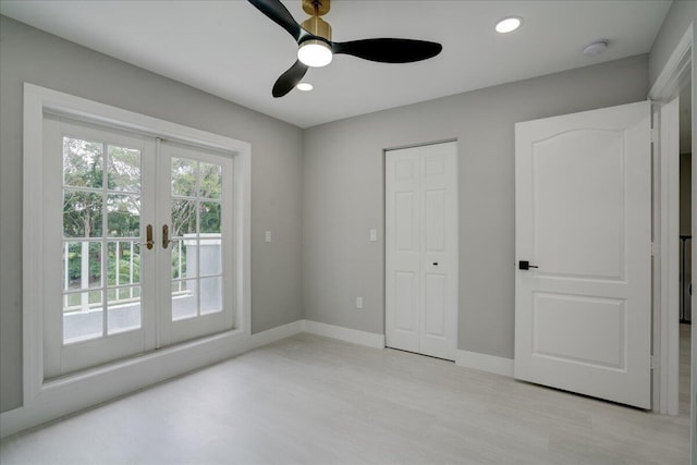 unfurnished bedroom with ceiling fan and french doors