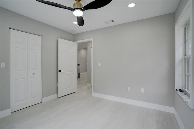 unfurnished bedroom with a closet and ceiling fan