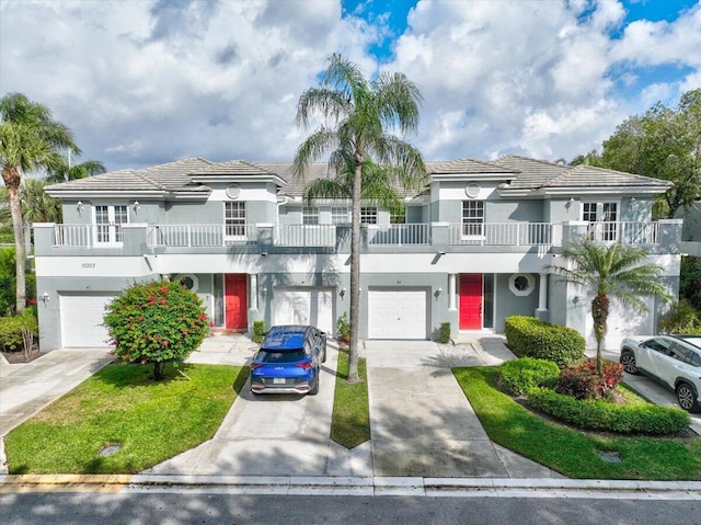 view of front of property with a balcony and a garage