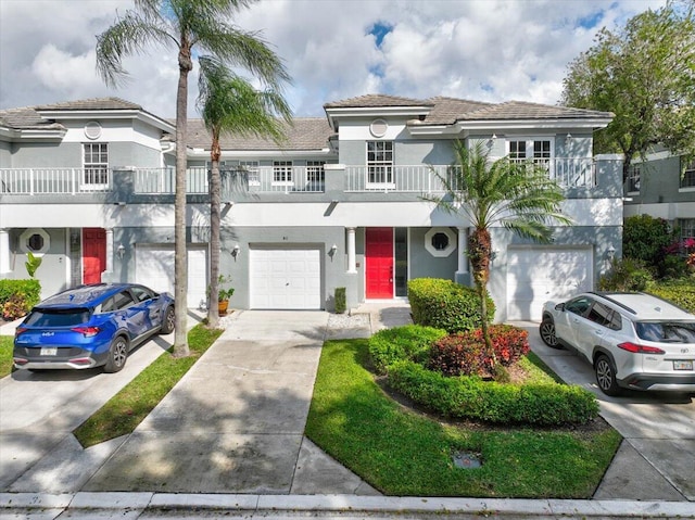 view of front of property featuring a balcony and a garage