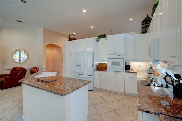 kitchen featuring sink, white cabinetry, and white appliances