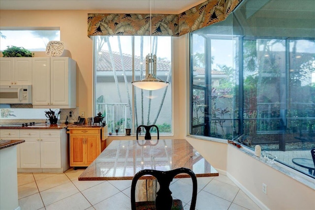 kitchen featuring white cabinetry, light tile patterned floors, and decorative backsplash