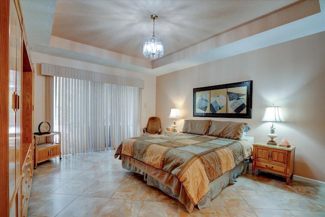 bedroom with a chandelier and a tray ceiling