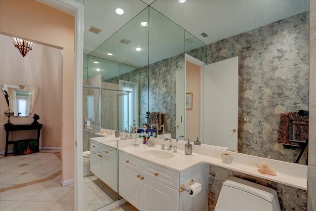 bathroom featuring toilet, walk in shower, vanity, and tile patterned flooring