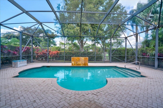 view of swimming pool featuring glass enclosure and a patio area