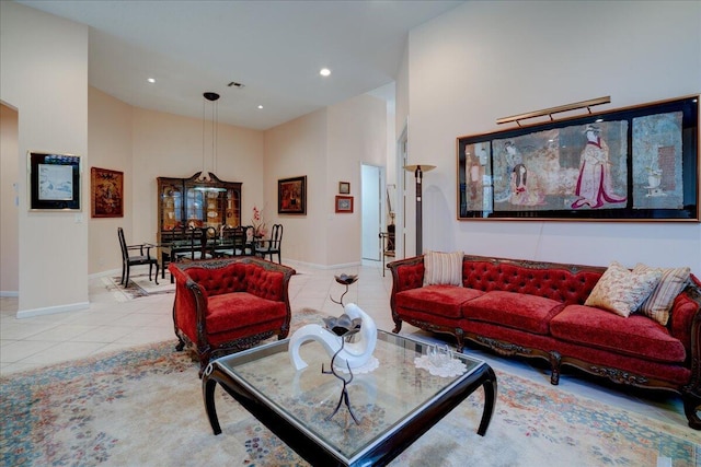 living room with light tile patterned flooring and a towering ceiling