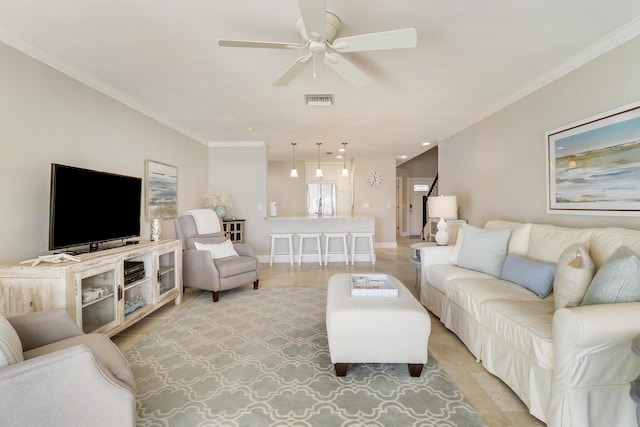 living room featuring ceiling fan, light tile patterned floors, and crown molding