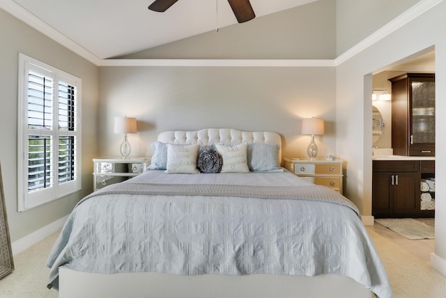 carpeted bedroom with ceiling fan, crown molding, ensuite bathroom, and lofted ceiling