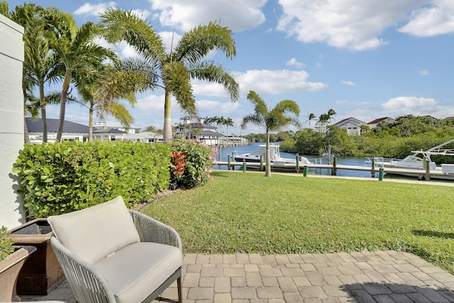 view of yard featuring a dock and a water view