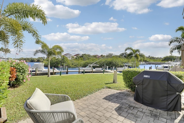 view of patio featuring a grill, a boat dock, and a water view