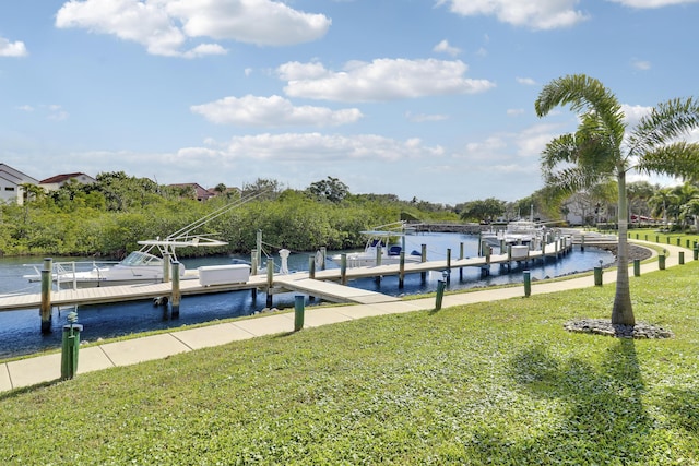 dock area with a lawn and a water view