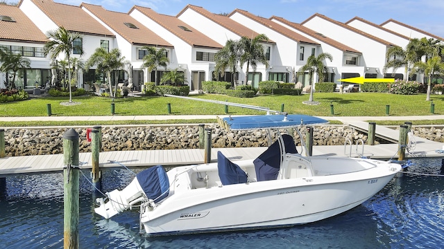 dock area with a water view and a lawn