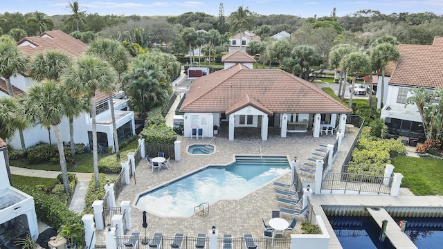 view of pool with a hot tub and a patio area