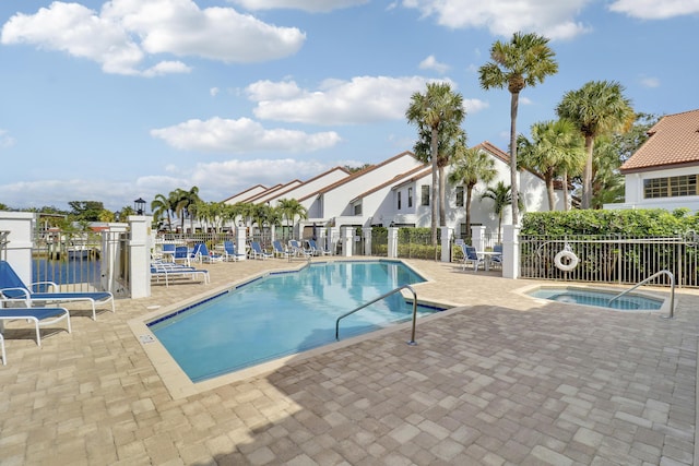 view of pool with a patio area and a water view