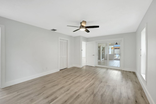 empty room featuring ceiling fan and light hardwood / wood-style flooring