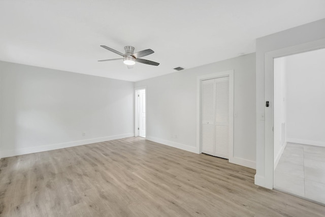 unfurnished room featuring ceiling fan and light hardwood / wood-style flooring