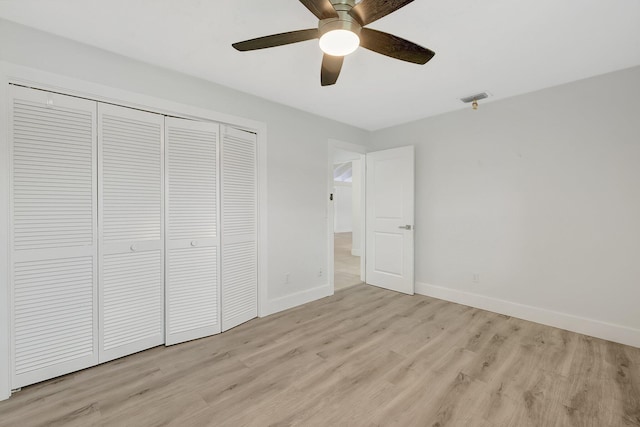 unfurnished bedroom featuring ceiling fan, a closet, and light hardwood / wood-style floors