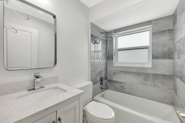 full bathroom with toilet, tiled shower / bath, and vanity