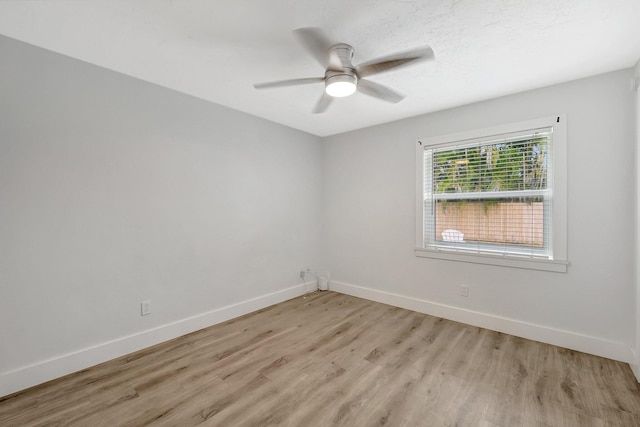 empty room featuring ceiling fan and light hardwood / wood-style flooring