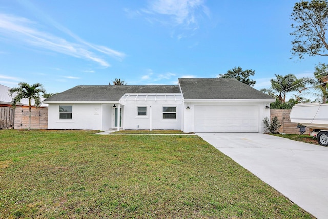 single story home featuring a front lawn and a garage