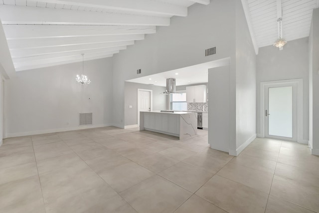 unfurnished living room featuring high vaulted ceiling, beamed ceiling, a notable chandelier, and light tile patterned flooring