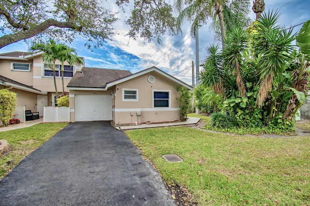 view of front of home featuring a garage and a front lawn