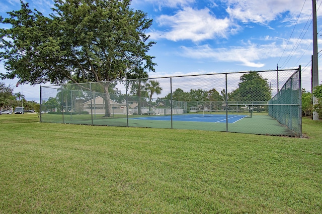 view of tennis court with a lawn