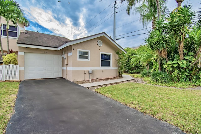 view of front facade with a front yard and a garage