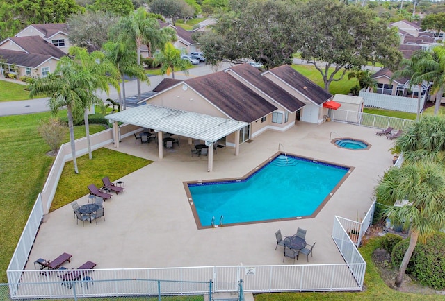 view of pool featuring a community hot tub, a patio area, and a lawn