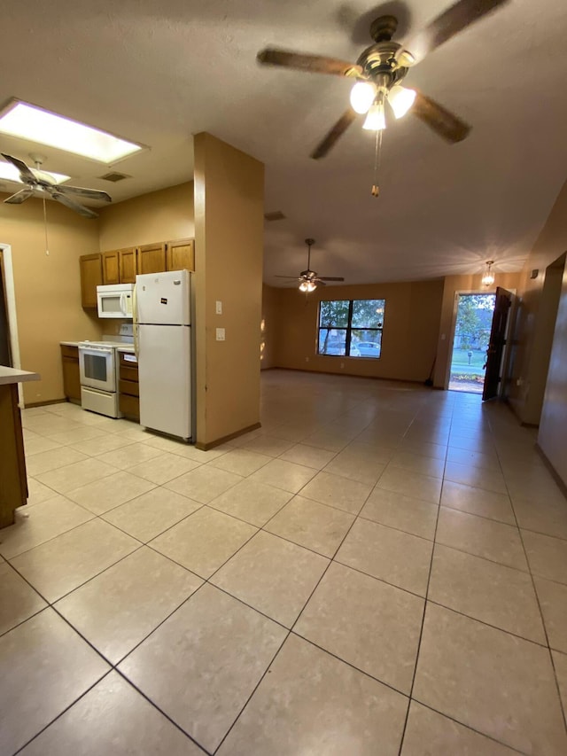 kitchen with white appliances, ceiling fan, and light tile patterned flooring