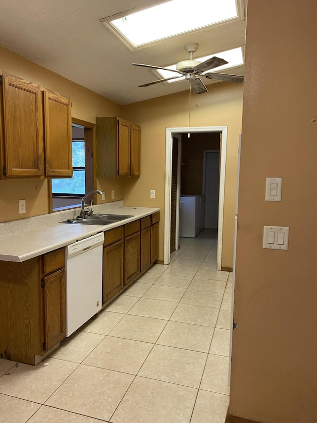 kitchen featuring sink, vaulted ceiling, light tile patterned flooring, ceiling fan, and white dishwasher