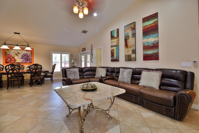 tiled living room with french doors, ceiling fan, and vaulted ceiling