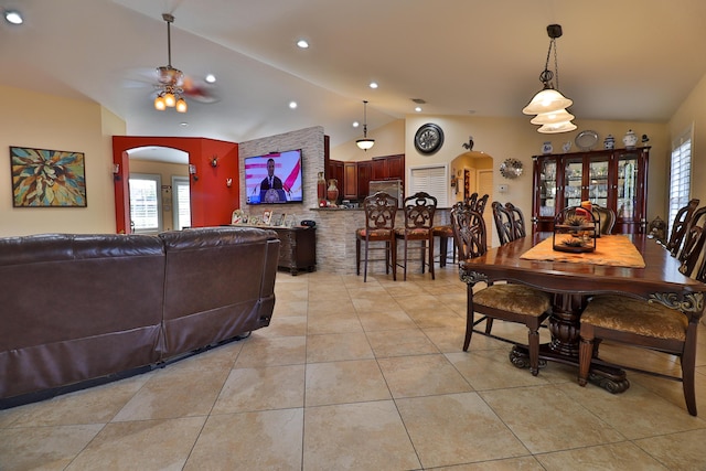 dining room with lofted ceiling, ceiling fan, light tile patterned floors, and a healthy amount of sunlight