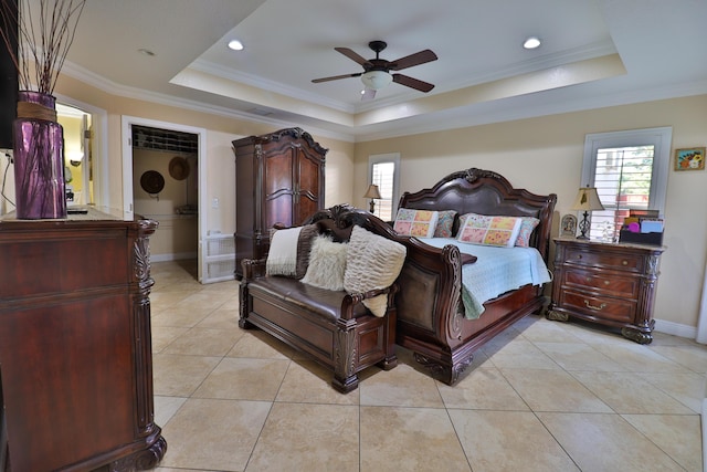 tiled bedroom with ornamental molding, ceiling fan, a tray ceiling, and multiple windows