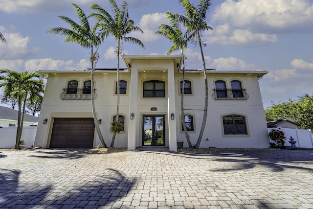 view of front of house featuring a balcony and a garage