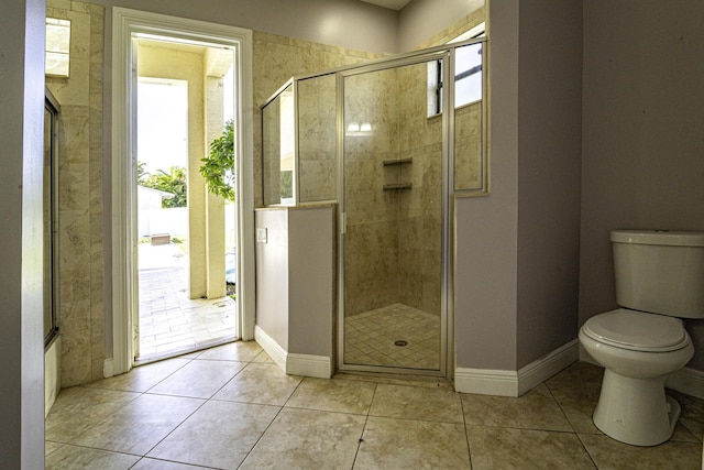 bathroom with toilet, an enclosed shower, and tile patterned flooring