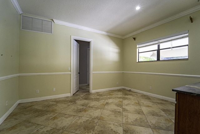 empty room featuring a textured ceiling and crown molding