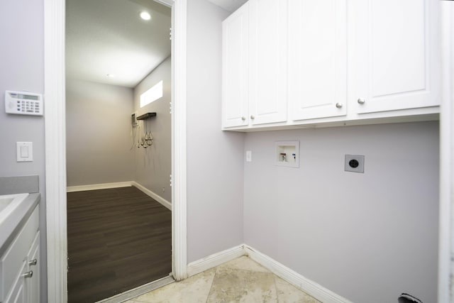 washroom featuring washer hookup, cabinets, hookup for an electric dryer, and light tile patterned flooring