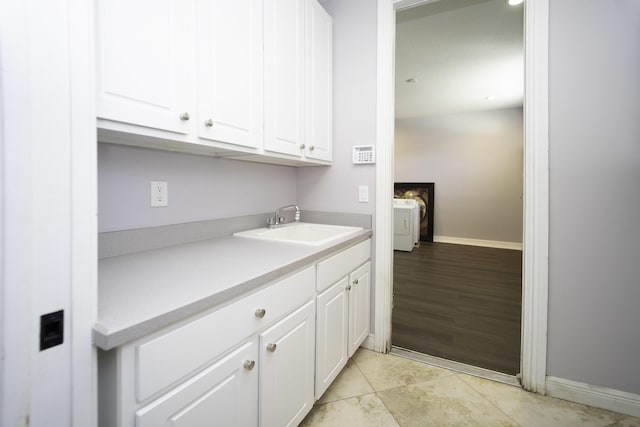 washroom with sink and washer / clothes dryer