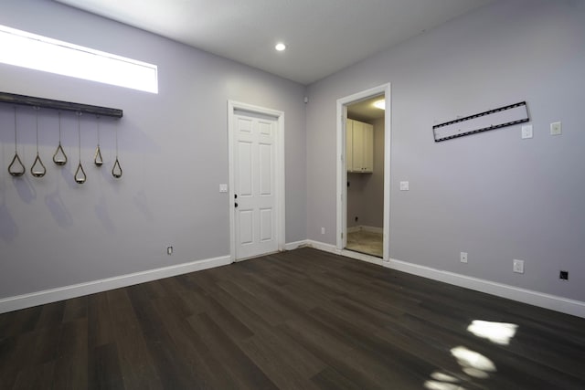 spare room featuring dark wood-type flooring