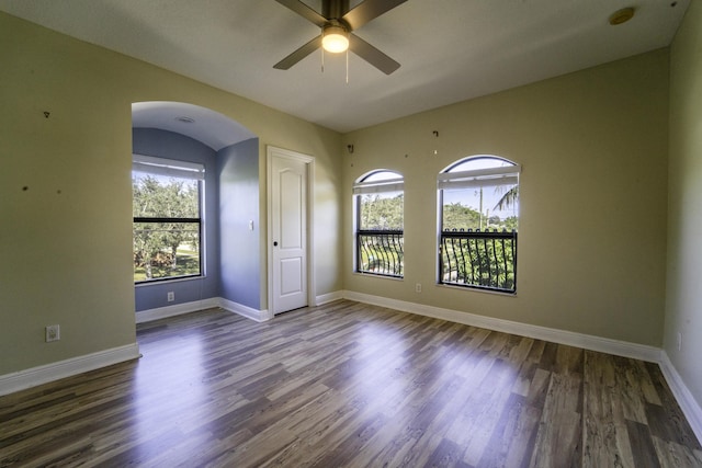 empty room with dark hardwood / wood-style flooring and ceiling fan