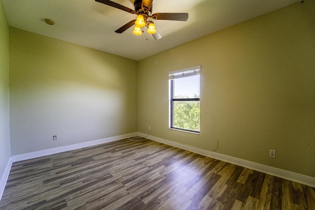 empty room featuring vaulted ceiling, ceiling fan, and dark hardwood / wood-style flooring