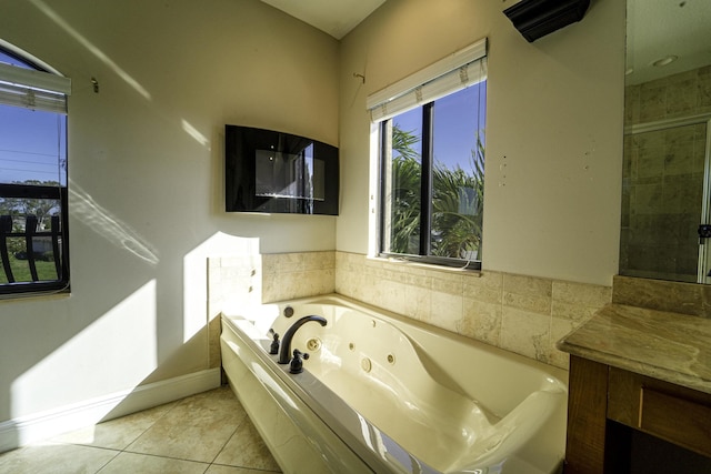 bathroom featuring a bathtub, vanity, and tile patterned floors