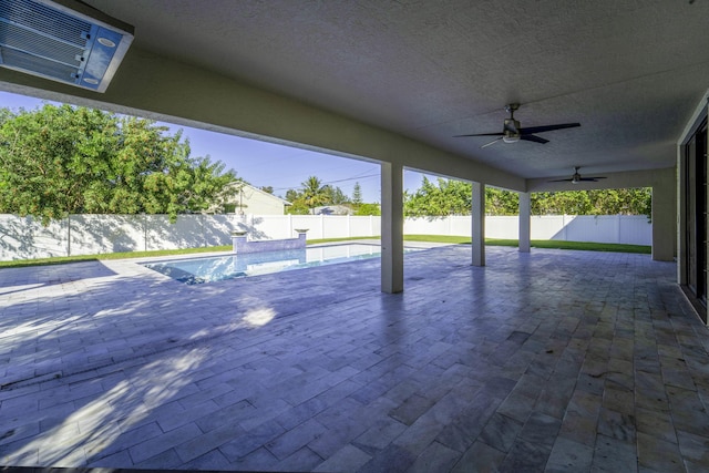 view of patio / terrace with ceiling fan and a fenced in pool