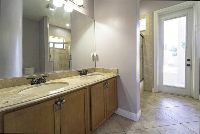 full bathroom with enclosed tub / shower combo, tile patterned flooring, vanity, and toilet