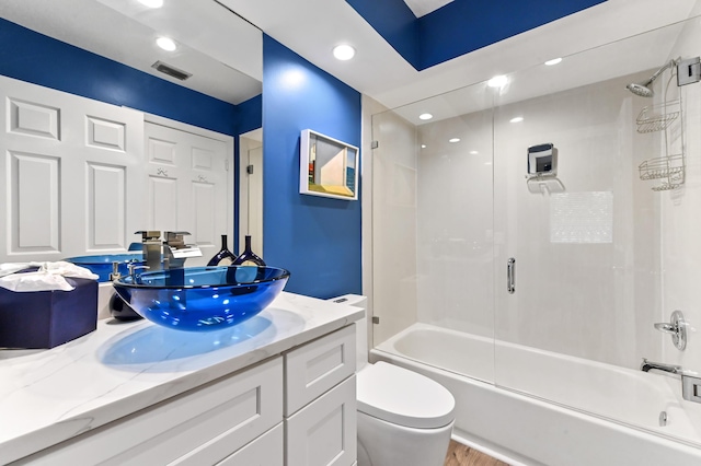 full bathroom featuring recessed lighting, visible vents, toilet, enclosed tub / shower combo, and vanity