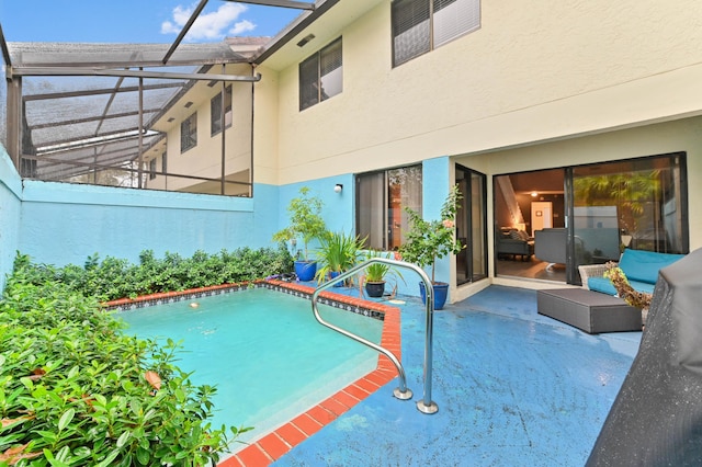 view of swimming pool featuring glass enclosure