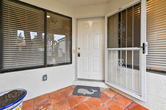 property entrance with stucco siding