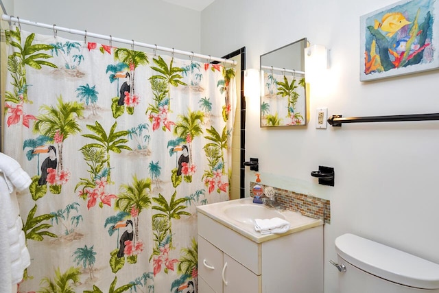 bathroom featuring vanity, backsplash, a shower with curtain, and toilet